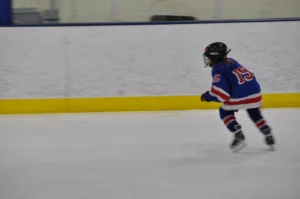 Jessie as a child skating in a hockey rink