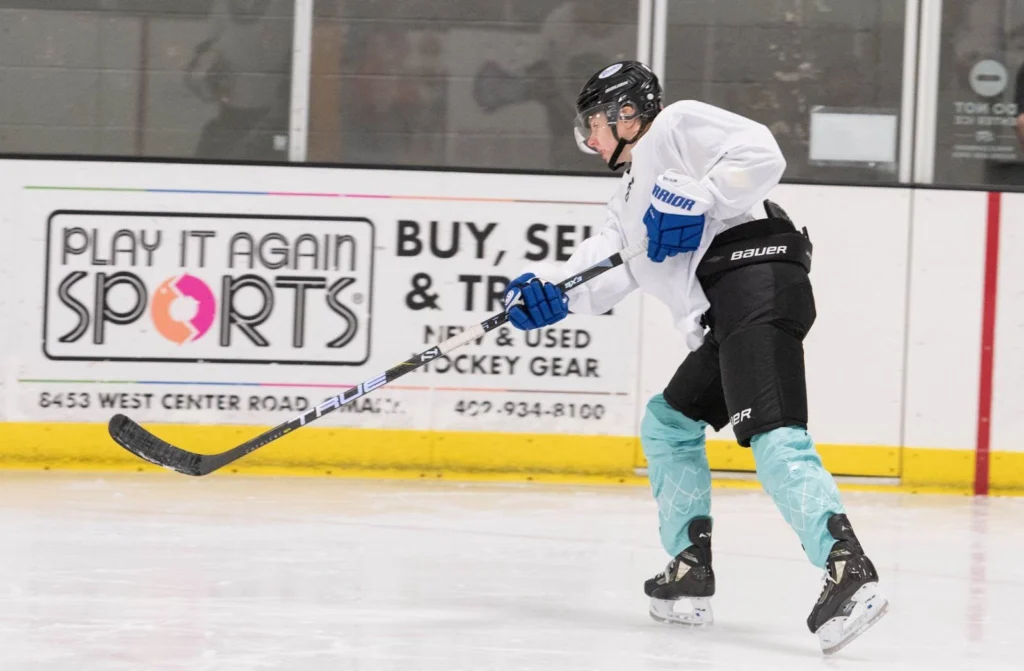 Jessie playing hockey in a hockey rink